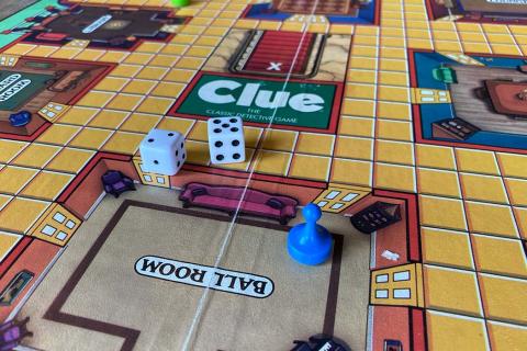 image of clue board game, dice, and pawn 