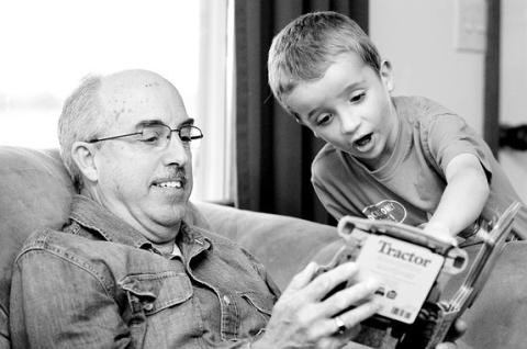 Grandfather reads to Grandson