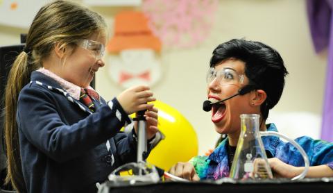 Girl and woman smiling over science experiment