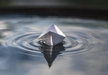 Paper boat on water.