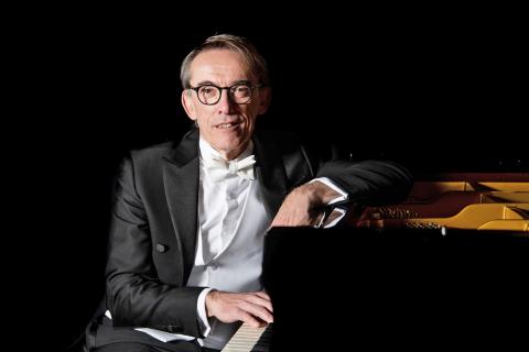 Andrea Turini sitting at a piano