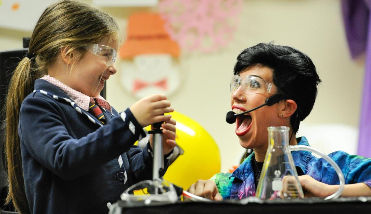 Girl and woman smiling over science experiment